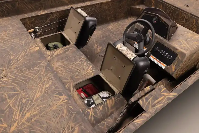 Slide: The Image of 2026 G3 Gator Tough 20 SC boat with camouflage interior, parked outdoors. - 5