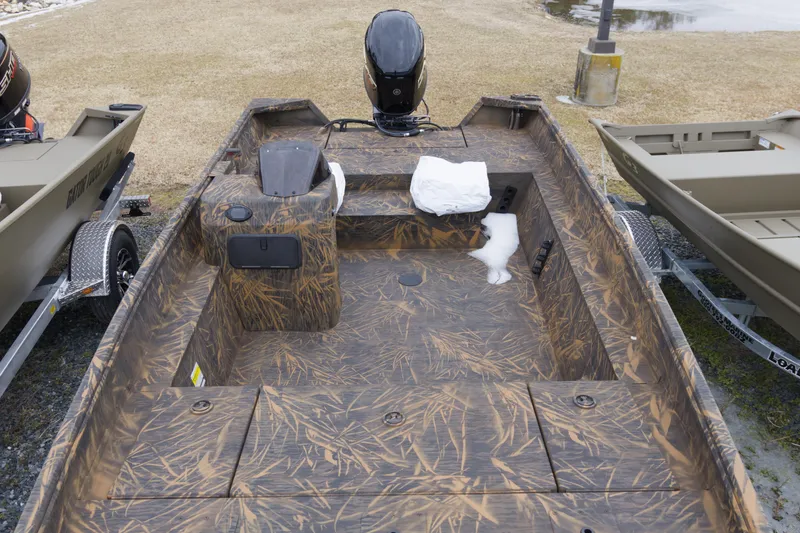 Slide: The Image of 2026 G3 Gator Tough 20 SC boat with camouflage interior, parked on a trailer. - 6