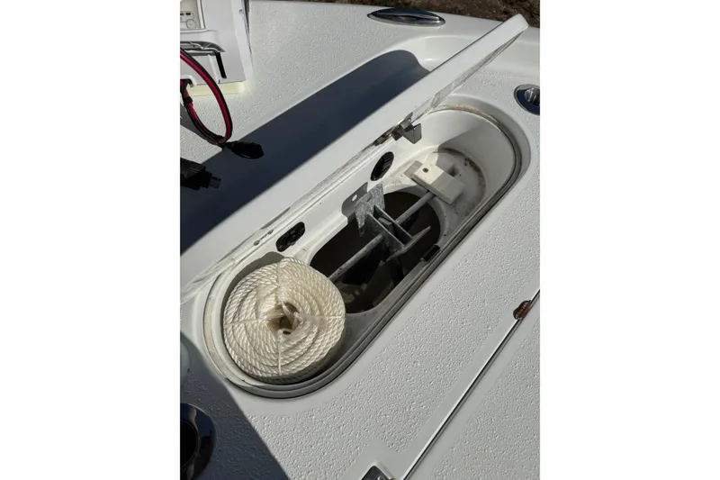 Slide: The Image of 2018 Yellowfin 21 Bay boat anchor compartment with rope and wiring. - 11