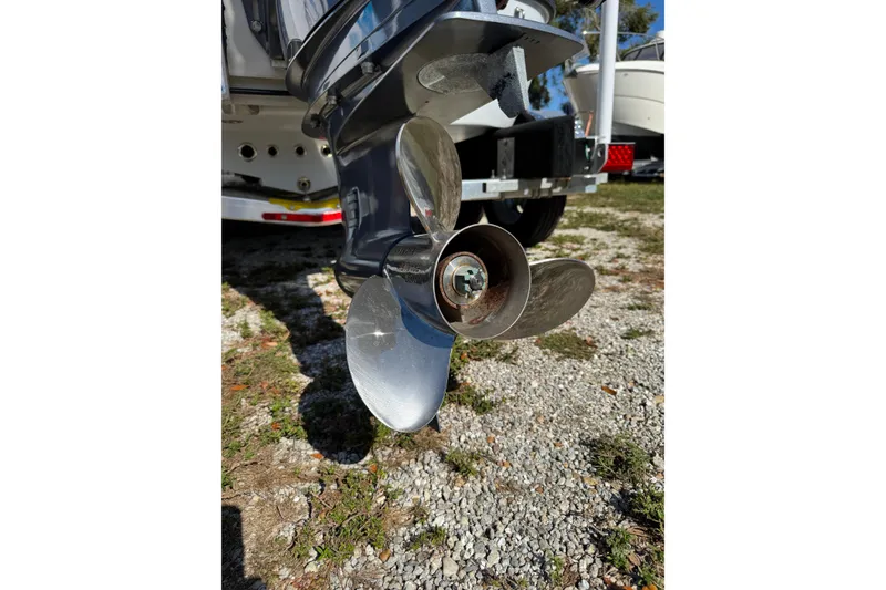 Slide: The Image of Close-up of a 2018 Yellowfin 21 Bay boat propeller on gravel surface. - 13