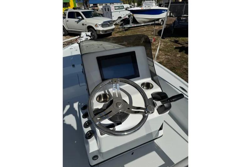 Slide: The Image of 2018 Yellowfin 21 Bay boat console with steering wheel and controls. - 14