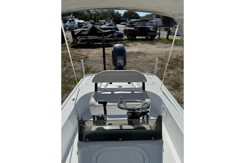 Slide: The Image of 2018 Yellowfin 21 Bay boat interior with steering wheel and Yamaha engine. - 18
