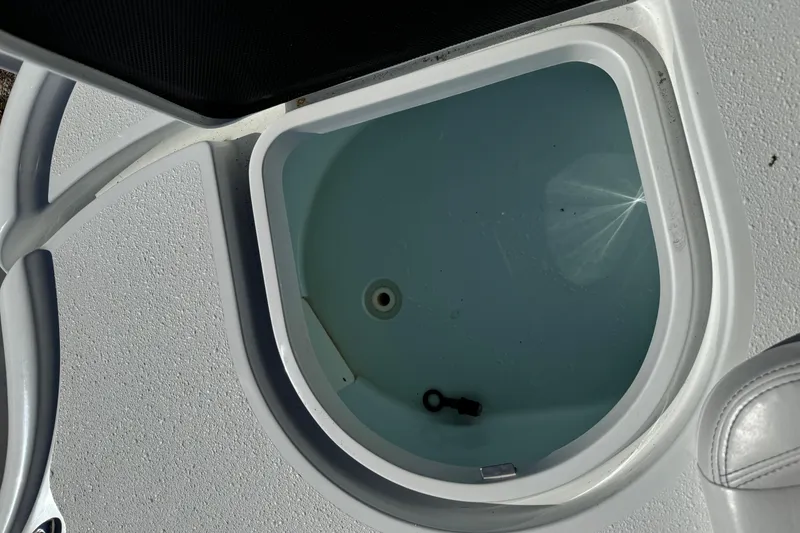 Slide: The Image of Livewell on 2018 Yellowfin 21 Bay boat, featuring clean interior and drain plug. - 21