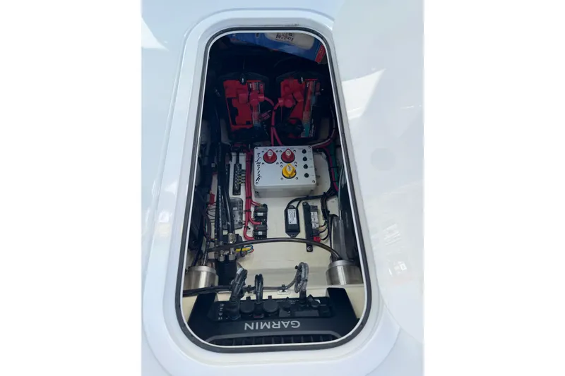 Slide: The Image of 2018 Yellowfin 21 Bay boat electrical compartment with batteries and wiring. - 22