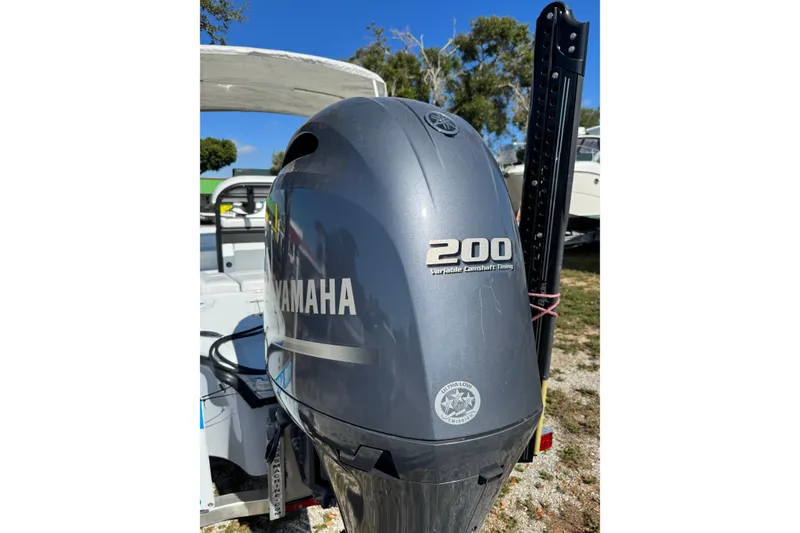 Slide: The Image of 2018 Yellowfin 21 Bay with Yamaha 200 outboard motor, parked outdoors. - 25