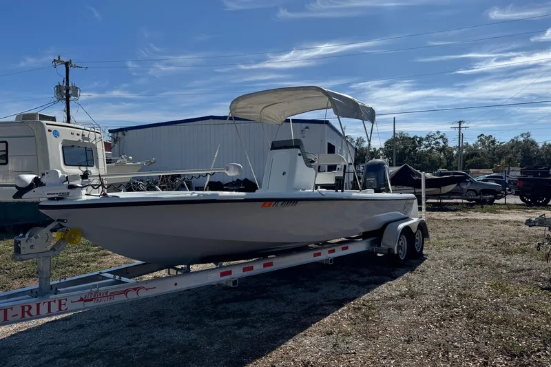 Slide: The Image of 2018 Yellowfin 21 Bay boat on trailer, parked outdoors under clear sky. - 3