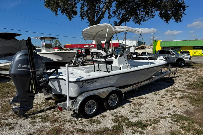 Slide: The Image of 2018 Yellowfin 21 Bay boat on trailer with Yamaha outboard motor, parked outdoors. - 6