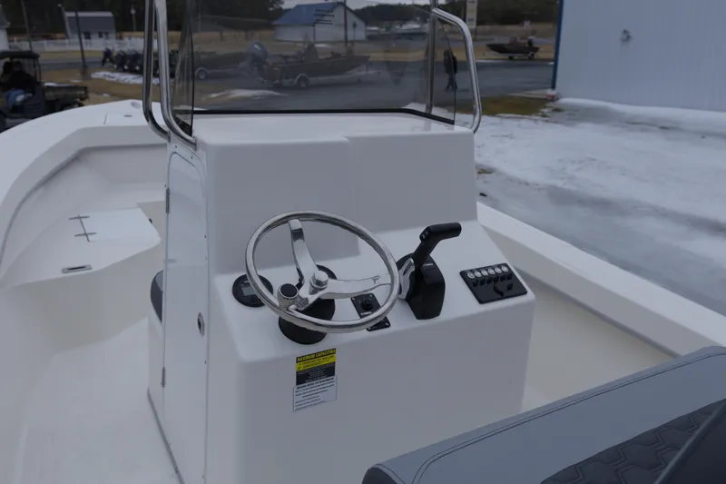 Slide: The Image of 2026 May-Craft 208 CC boat console with steering wheel and controls. - 12