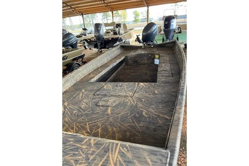 Slide: The Image of 2026 G3 Gator Tough 17 DK boat with camouflage design under a shelter. - 3