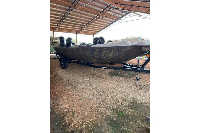Slide: The Image of 2026 G3 Gator Tough 17 DK boat under a metal canopy on a gravel surface. - 5