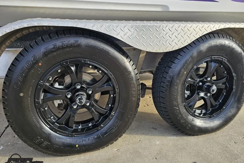 Slide: The Image of 2003 Baja 25 Outlaw trailer with black alloy wheels and radial tires. - 12