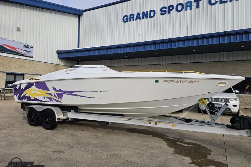 Slide: The Image of 2003 Baja 25 Outlaw speedboat on trailer at Grand Sport Center. - 14