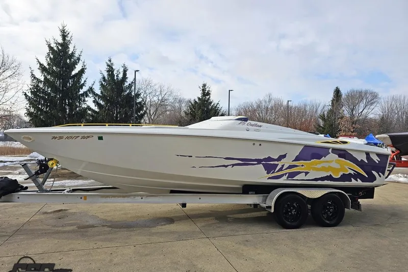 Slide: The Image of 2003 Baja 25 Outlaw speedboat on trailer, featuring vibrant purple and yellow graphics. - 17