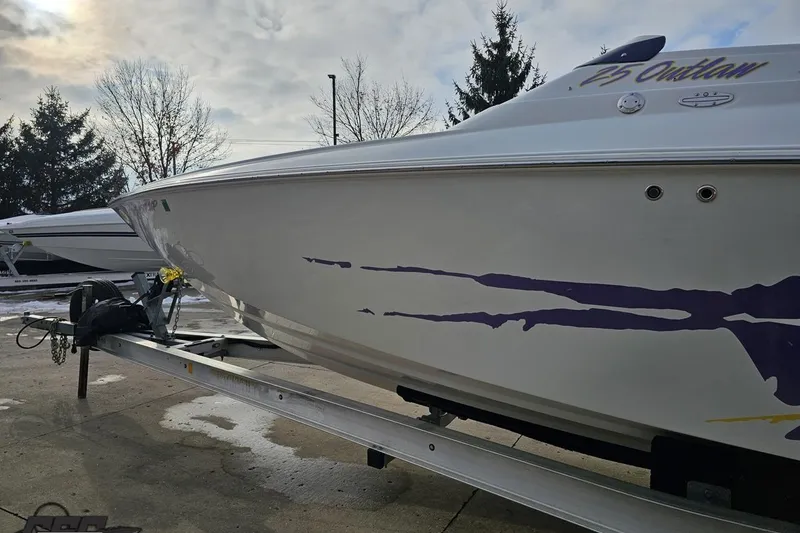 Slide: The Image of 2003 Baja 25 Outlaw boat on trailer, featuring sleek design and vibrant graphics. - 20