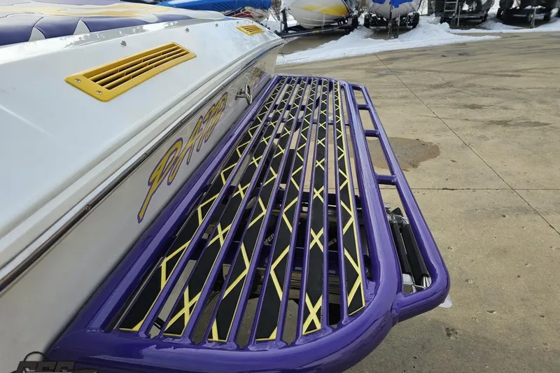 Slide: The Image of 2003 Baja 25 Outlaw boat with custom purple and yellow swim platform. - 29