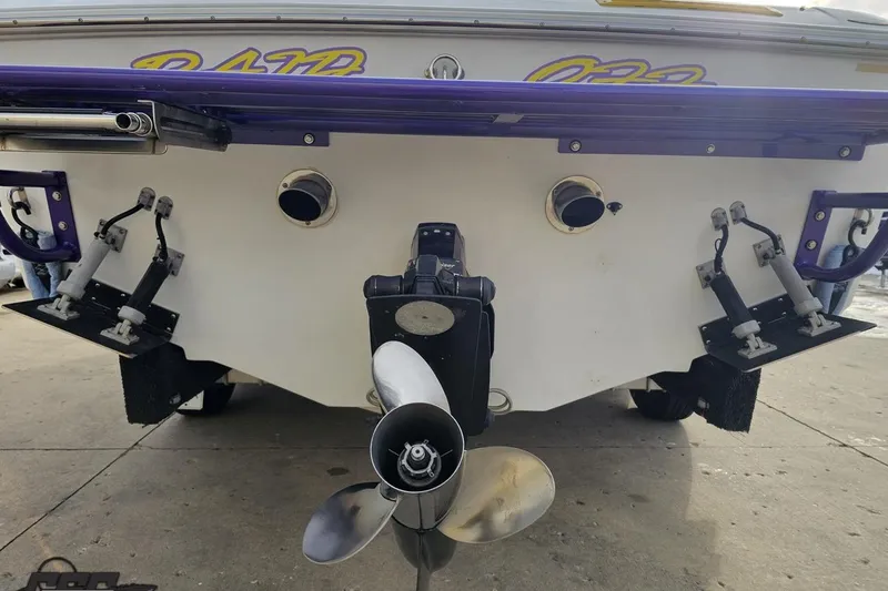 Slide: The Image of Rear view of a 2003 Baja 25 Outlaw boat with visible propeller and trim tabs. - 31