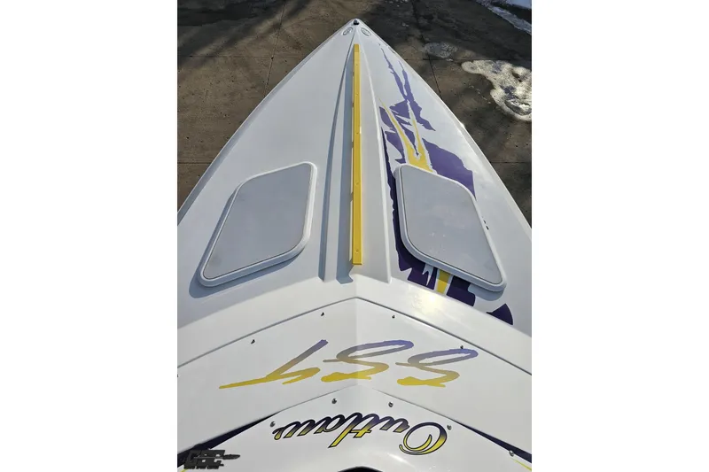 Slide: The Image of 2003 Baja 25 Outlaw boat with vibrant graphics and sleek design. - 40
