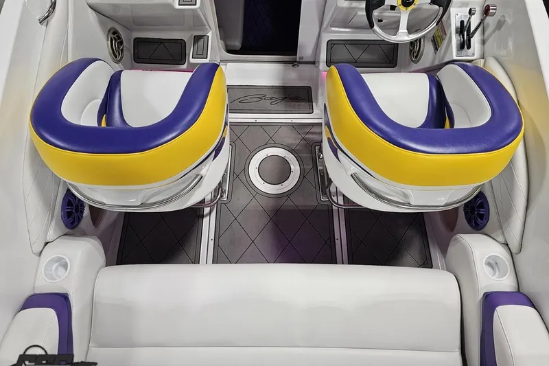 Slide: The Image of 2003 Baja 25 Outlaw boat interior with vibrant yellow and purple seating. - 52