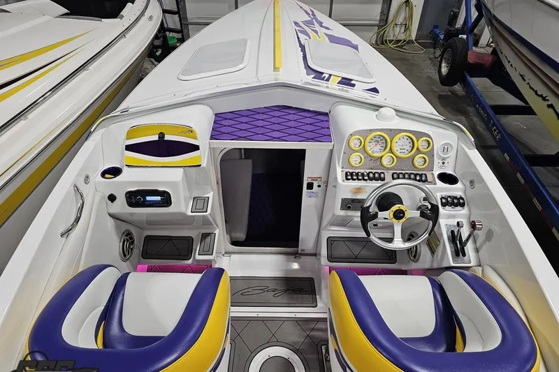Slide: The Image of 2003 Baja 25 Outlaw boat interior with vibrant purple and yellow accents. - 53