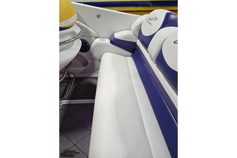 Slide: The Image of 2003 Baja 25 Outlaw boat interior with white and purple seating. - 55
