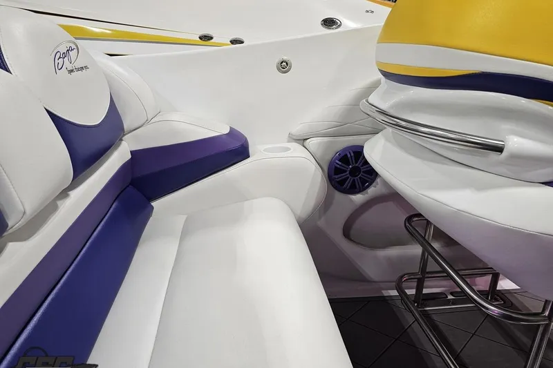 Slide: The Image of Interior of 2003 Baja 25 Outlaw boat with white and purple seating. - 57