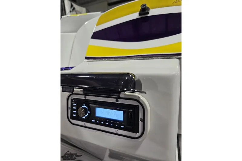 Slide: The Image of 2003 Baja 25 Outlaw boat with stereo system and colorful design accents. - 61