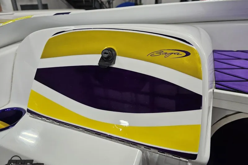 Slide: The Image of 2003 Baja 25 Outlaw boat with vibrant yellow and purple design accents. - 63