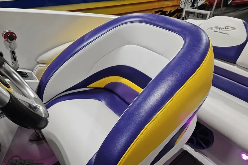 Slide: The Image of 2003 Baja 25 Outlaw boat interior with vibrant purple, yellow, and white seating. - 68