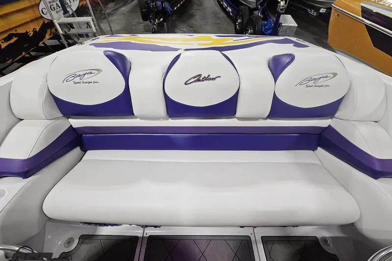 Slide: The Image of 2003 Baja 25 Outlaw boat interior with white and purple seating. - 72