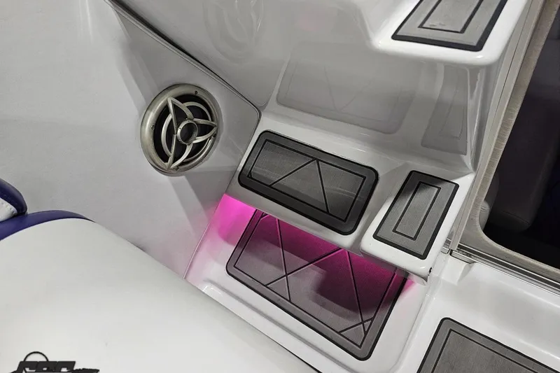 Slide: The Image of 2003 Baja 25 Outlaw boat interior with speaker and illuminated steps. - 77