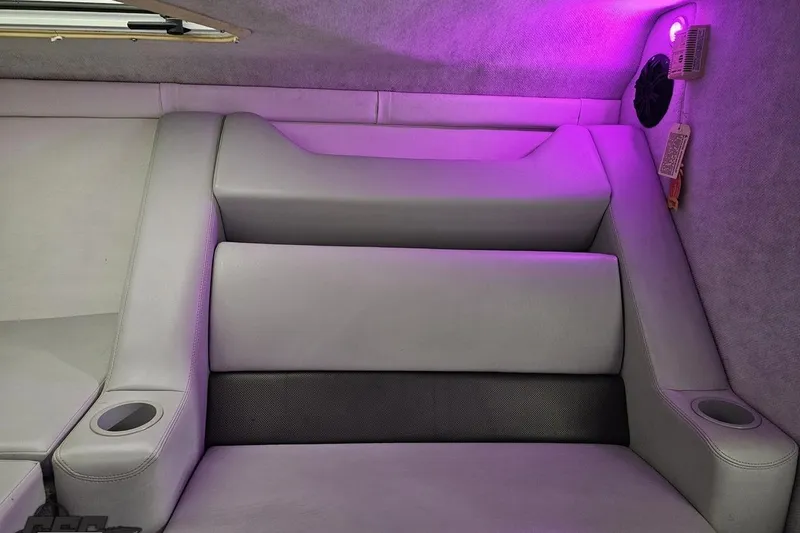 Slide: The Image of Interior of a 2003 Baja 25 Outlaw boat with purple ambient lighting. - 79