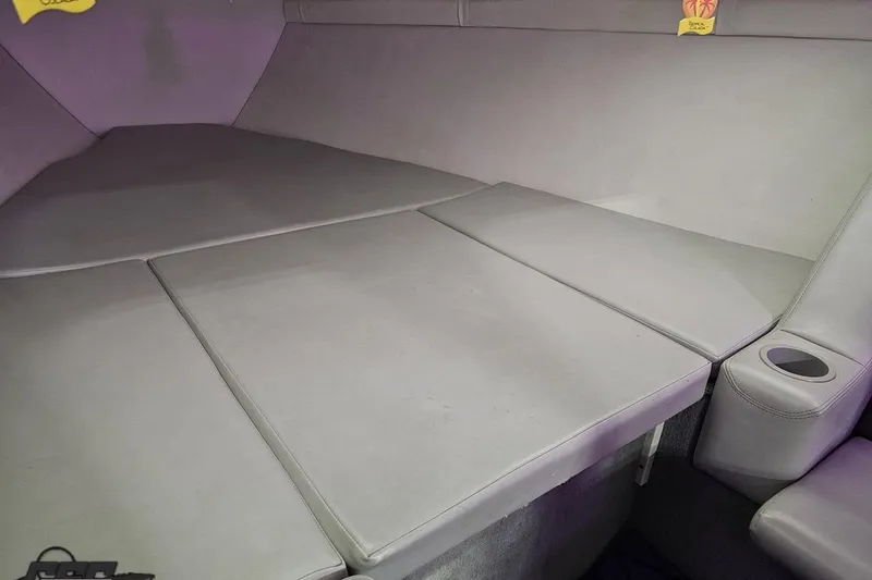 Slide: The Image of 2003 Baja 25 Outlaw interior cabin with cushioned seating and cup holder. - 83