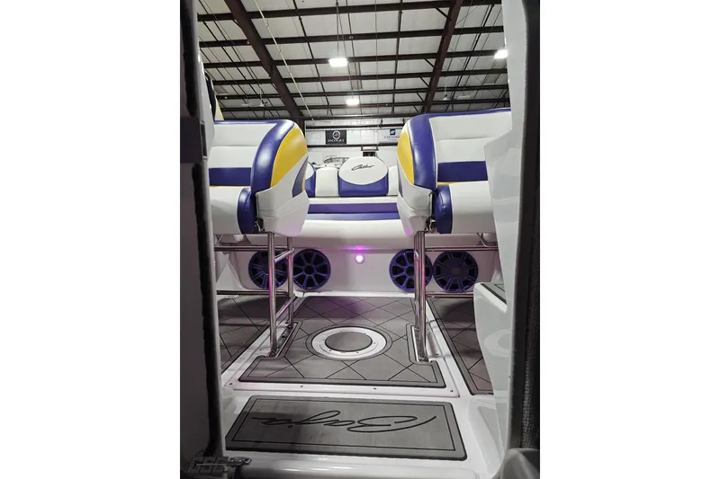 Slide: The Image of 2003 Baja 25 Outlaw boat interior with vibrant seating and modern design. - 85
