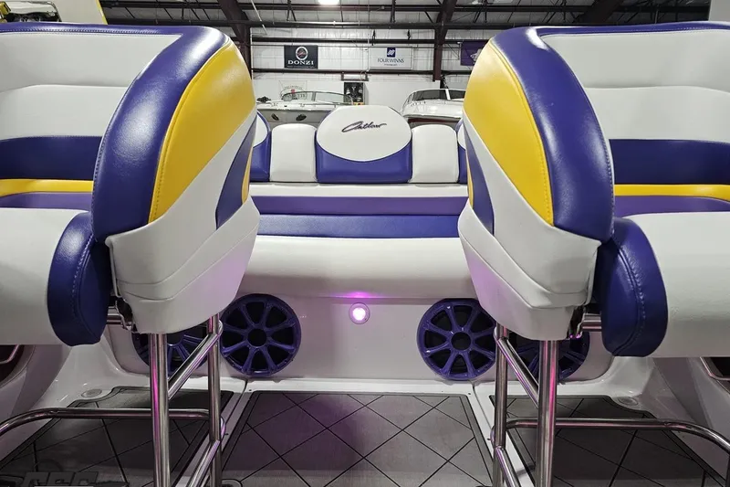 Slide: The Image of 2003 Baja 25 Outlaw boat interior with vibrant yellow and purple seating. - 87