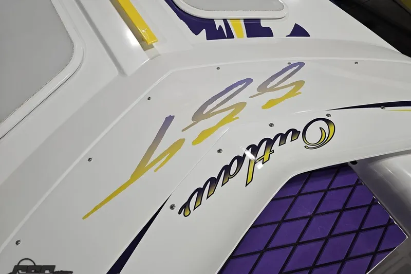 Slide: The Image of 2003 Baja 25 Outlaw boat with vibrant graphics and sleek design details. - 89