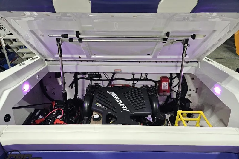 Slide: The Image of 2003 Baja 25 Outlaw boat engine compartment with Mercury engine and purple LED lights. - 93
