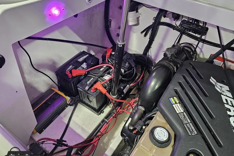 Slide: The Image of 2003 Baja 25 Outlaw engine compartment with batteries and wiring. - 97