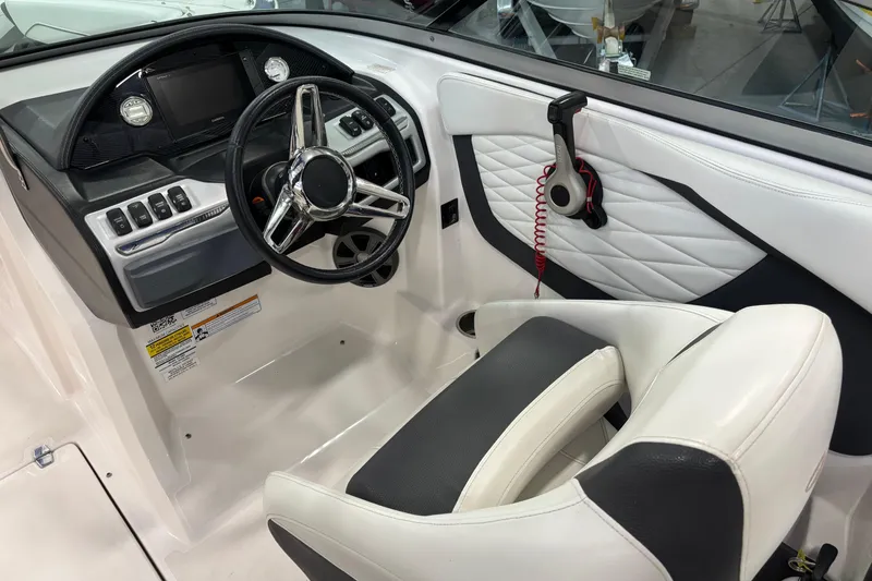Slide: The Image of 2018 Regal 23 OBX boat interior with white seating and cup holders. - 13