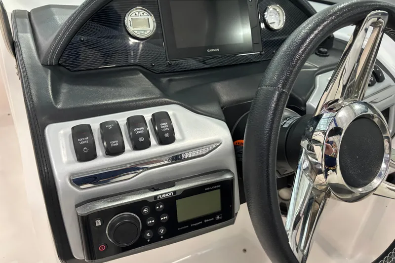 Slide: The Image of 2018 Regal 23 OBX boat interior with white leather seating and cup holders. - 14