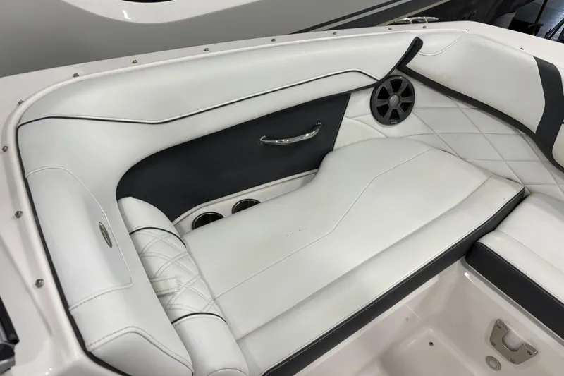 Slide: The Image of 2018 Regal 23 OBX boat interior with white leather seating and speaker detail. - 17