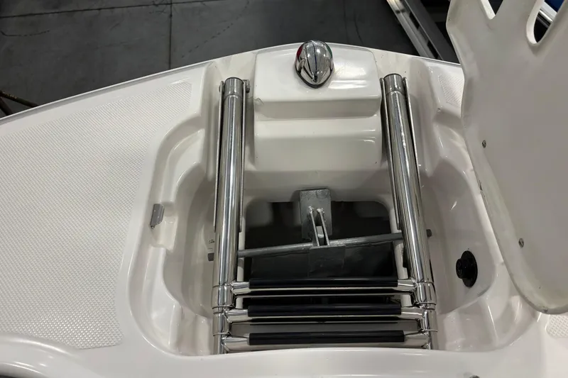 Slide: The Image of Luxurious white seating in 2018 Regal 23 OBX boat interior with speaker and handle. - 18