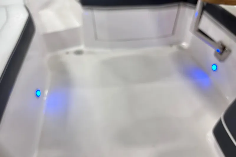 Slide: The Image of Interior of 2018 Regal 23 OBX boat with blue LED lights and seating. - 25