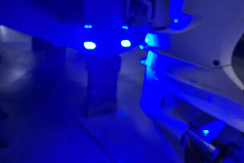 Slide: The Image of Blue LED lights on a 2018 Regal 23 OBX boat in a dimly lit setting. - 26