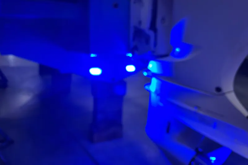 Slide: The Image of 2018 Regal 23 OBX boat with vibrant blue LED lights illuminating the interior. - 27