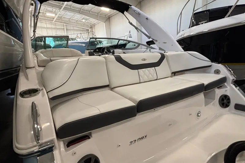 Slide: The Image of 2018 Regal 23 OBX boat in storage, blue hull, indoor facility. - 7