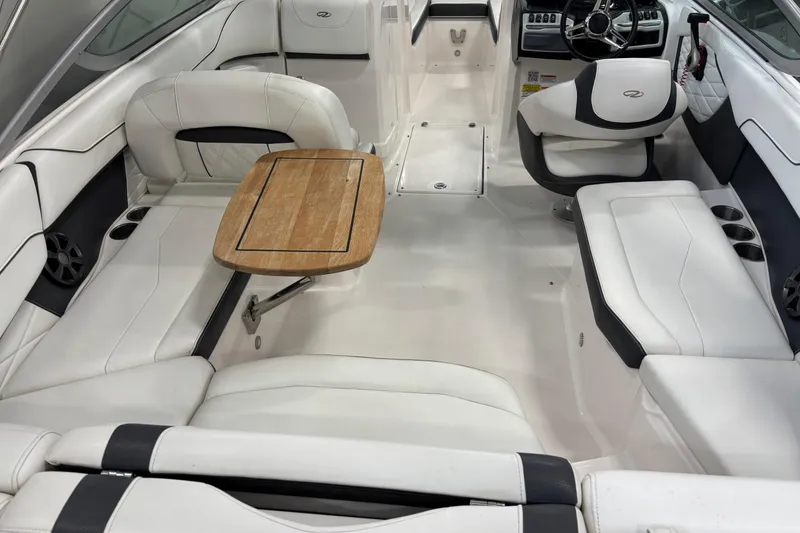 Slide: The Image of 2018 Regal 23 OBX boat in showroom, blue and white exterior, on display stands. - 9