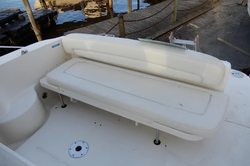Slide: The Image of 2004 Sea Ray 300 Sundancer boat with white seating area by the dock. - 10