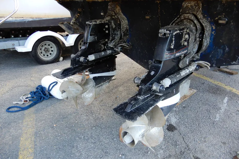 Slide: The Image of 2004 Sea Ray 300 Sundancer boat propellers and outdrives on a trailer. - 17