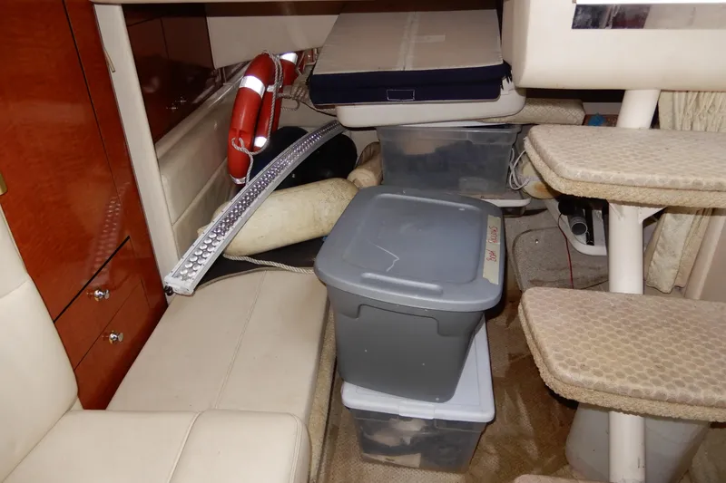 Slide: The Image of Interior of a 2004 Sea Ray 300 Sundancer with storage bins and life preserver. - 6