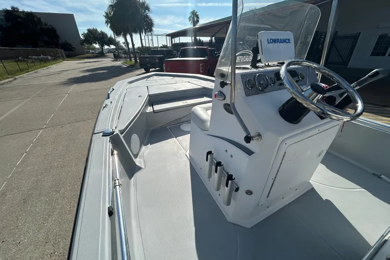Slide: The Image of 2017 Blue Wave 1900 STL boat with steering console, parked outdoors under sunny skies. - 13